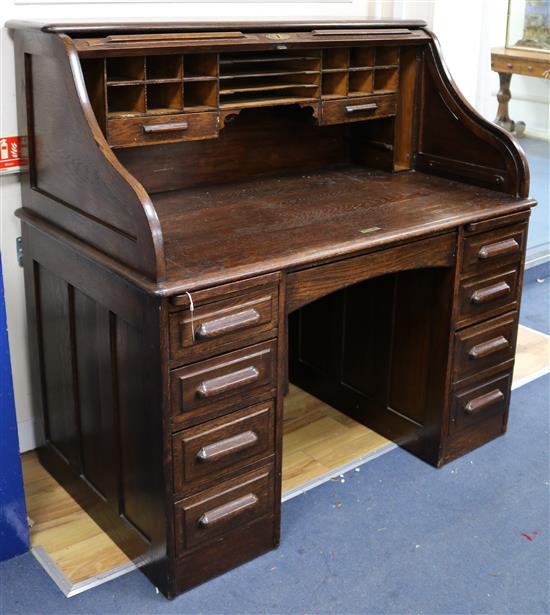 A 1920s oak roll top desk W.127cm